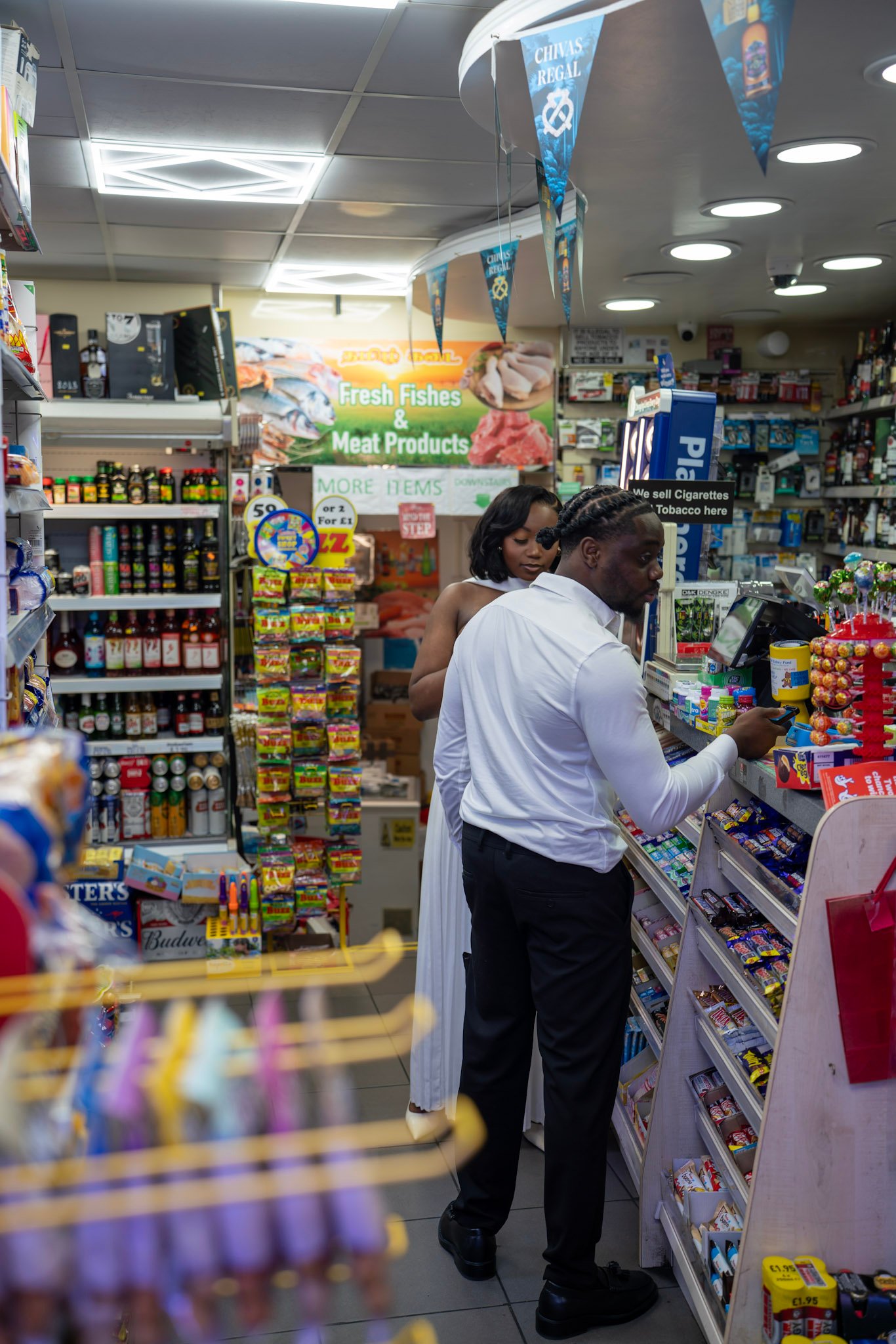 A couple making an unplanned stop at a corner shop
