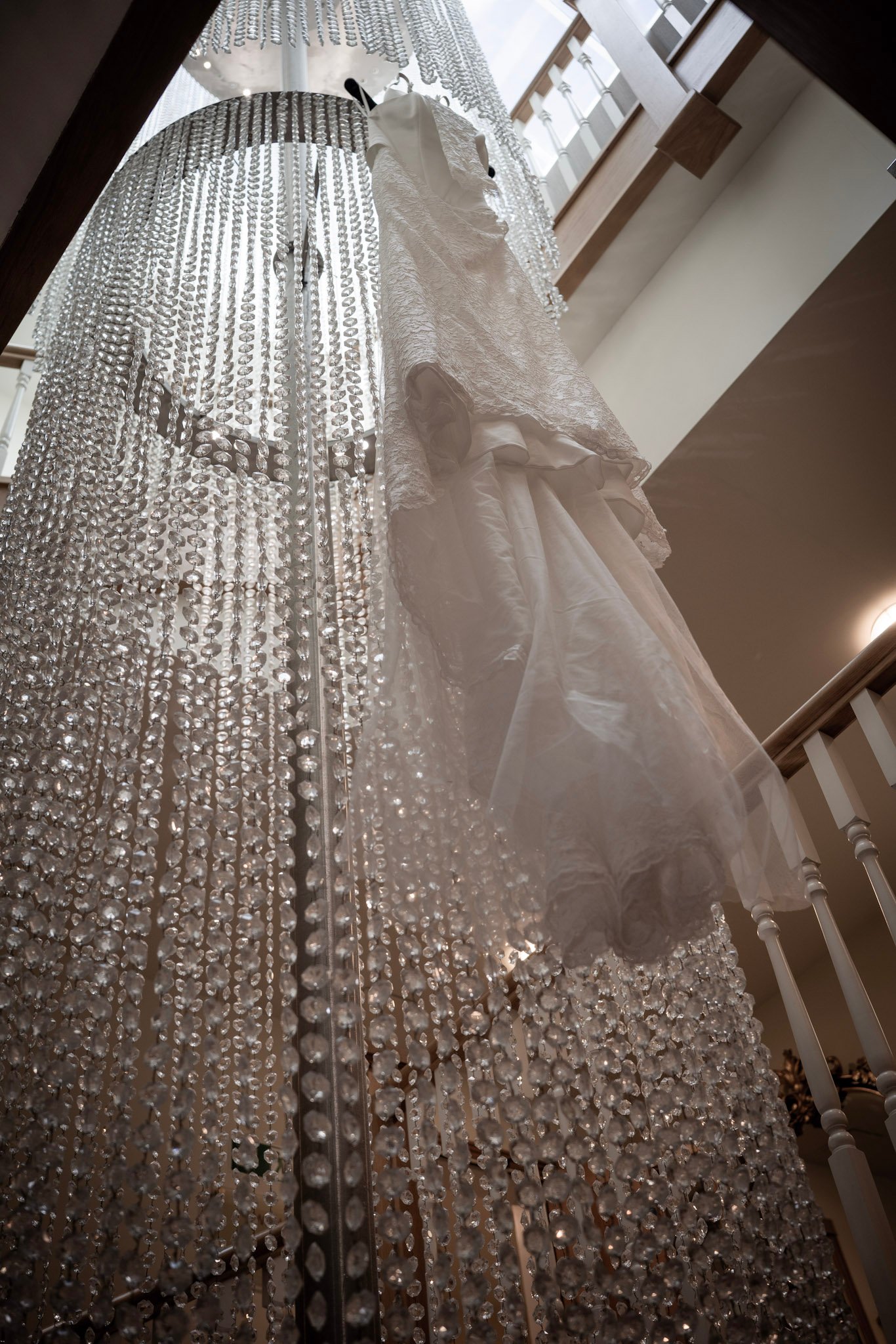A wedding dress seen through a beaded curtain