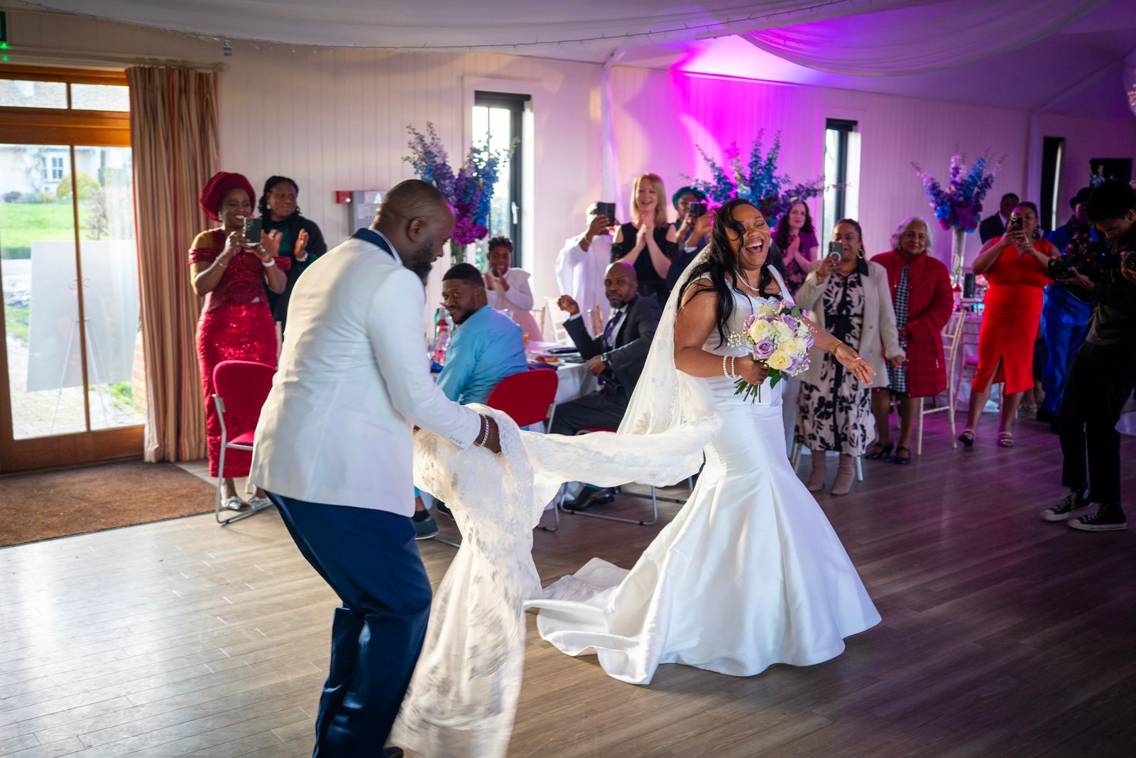 A bride and groom laughing during their reception