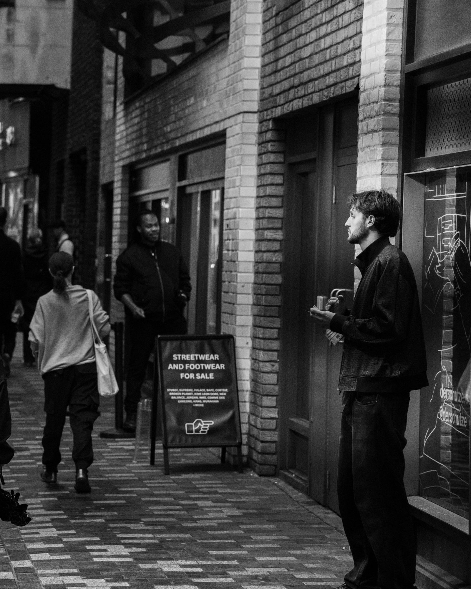 Man waiting outside a brick building