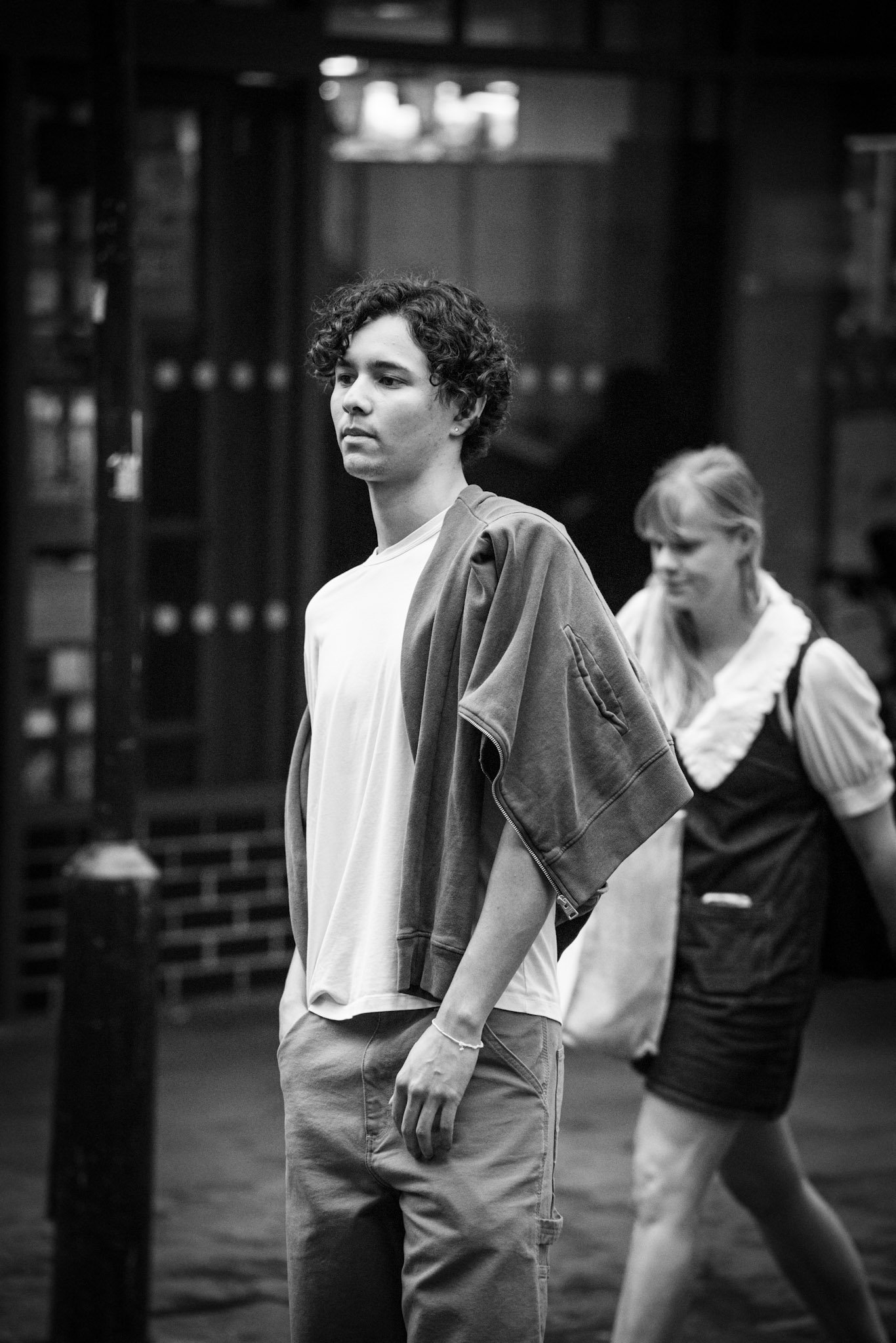 Young man walking through a crowded street