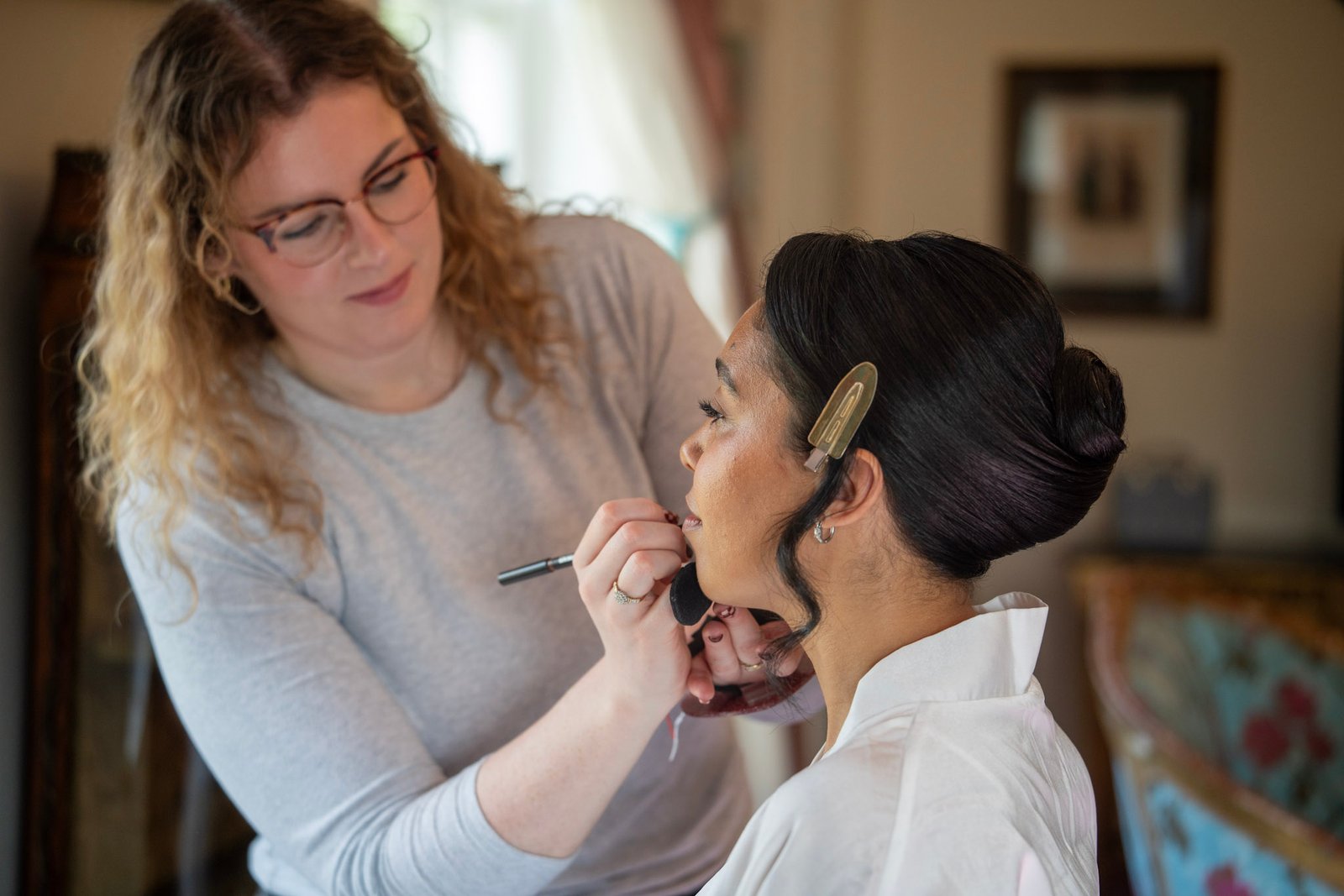 Bride having makeup applied