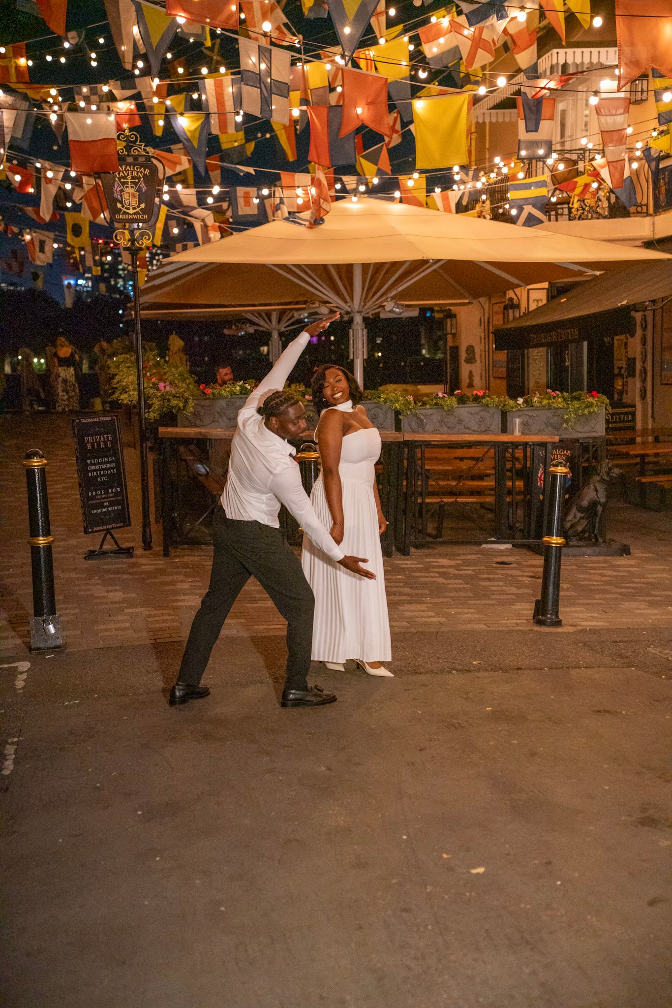 Bride and groom dancing outside