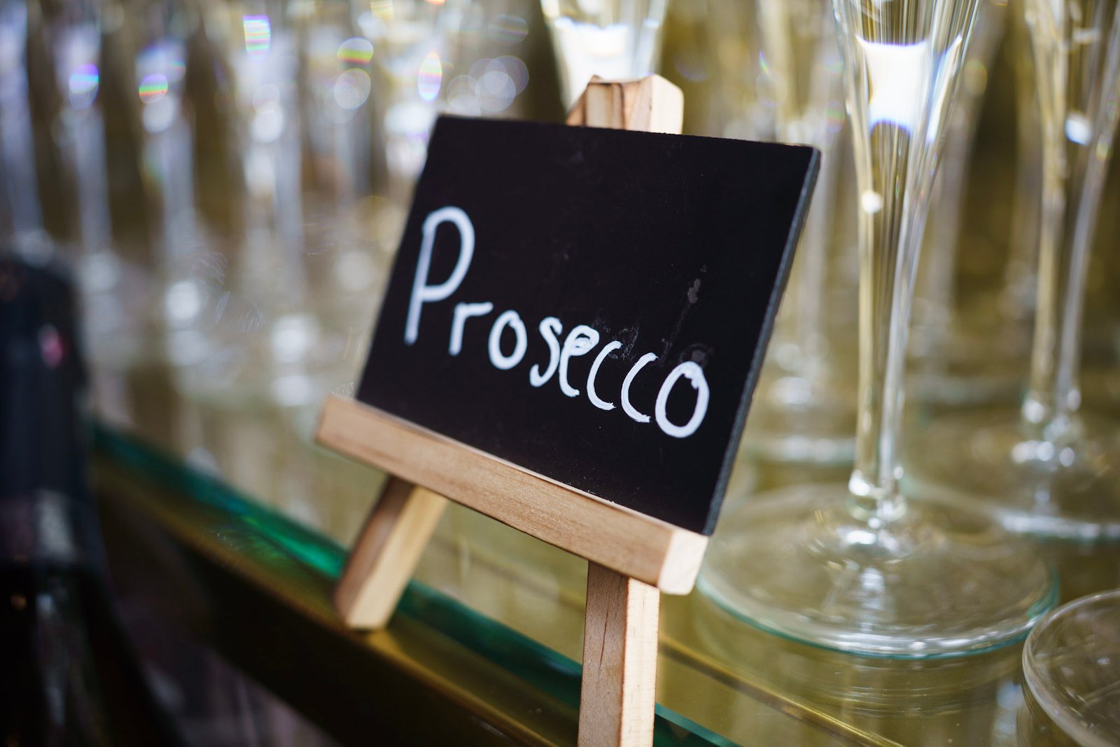 Prosecco sign beside reception glasses
